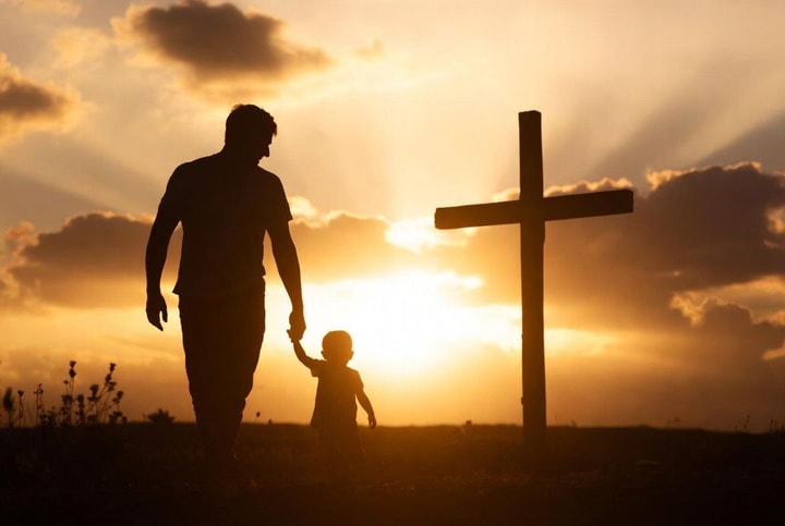 Father and child walking hand in hand toward a cross at sunset — You Are Not Weak
