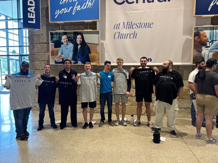Men's Freedom group holding shirts at Milestone Church